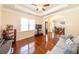 Comfortable living room showcasing hardwood flooring, tray ceilings, and lots of natural light at 100 Marshas Vineyard, Hampton, GA 30228