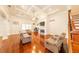 Spacious living room boasting hardwood floors, fireplace, and comfortable seating at 100 Marshas Vineyard, Hampton, GA 30228