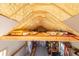 Spacious loft area in garage showcases rafter insulation and storage with shelving at 100 Marshas Vineyard, Hampton, GA 30228