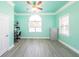Bright home office with a ceiling fan, large arched window, and gray flooring at 100 Marshas Vineyard, Hampton, GA 30228