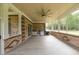 Spacious screened-in porch with brick details, outdoor kitchen setup, and tile flooring at 100 Marshas Vineyard, Hampton, GA 30228