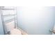 Close up of a toilet with a metal storage rack above at 100 Marshas Vineyard, Hampton, GA 30228