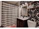 Stylish bathroom with leaf-patterned shower curtain, decorative wallpaper, and vanity at 3116 Jackson St, Hapeville, GA 30354
