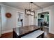 Bright dining room with modern light fixture, white bench seating, and doorway to kitchen at 3116 Jackson St, Hapeville, GA 30354