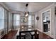 Elegant dining room with modern lighting, seating for four, and view into kitchen at 3116 Jackson St, Hapeville, GA 30354