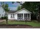 Charming home with a white exterior, inviting screened-in porch, and well-maintained front yard at 3116 Jackson St, Hapeville, GA 30354