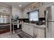 Well-lit kitchen featuring stainless steel appliances and black backsplash at 3116 Jackson St, Hapeville, GA 30354
