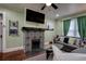 Inviting living room featuring a decorative fireplace, mounted television, and comfortable seating at 3116 Jackson St, Hapeville, GA 30354