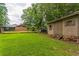 Backyard featuring a brick house and shed, perfect for storage and outdoor activities at 3553 Lakeview Dr, Rex, GA 30273