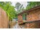 Backyard brick house featuring a wooden deck that leads to a refreshing in-ground pool for outdoor relaxation at 3553 Lakeview Dr, Rex, GA 30273