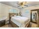 Cozy bedroom featuring large windows, ceiling fan, and ample closet space at 3553 Lakeview Dr, Rex, GA 30273