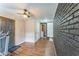 Bonus room with painted brick feature wall and ceiling fan at 3553 Lakeview Dr, Rex, GA 30273