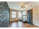 Bonus room with painted brick accent wall featuring vinyl floors at 3553 Lakeview Dr, Rex, GA 30273