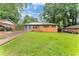 Charming one-story brick home with a spacious front yard and mature trees, offering great curb appeal at 3553 Lakeview Dr, Rex, GA 30273