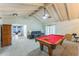 Spacious game room with vaulted ceilings and a classic pool table at 3553 Lakeview Dr, Rex, GA 30273