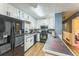 Modern kitchen with white cabinets, black appliances, and wood floors, perfect for cooking and entertaining at 3553 Lakeview Dr, Rex, GA 30273