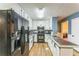 Modern kitchen with white cabinets, black appliances, and wood floors, a great space for cooking at 3553 Lakeview Dr, Rex, GA 30273