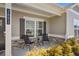 Inviting front porch with brick accents, seating, and well-maintained landscaping at 3891 Shelleydale Dr, Powder Springs, GA 30127