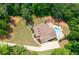 An aerial shot of a house with a backyard pool, patio, and landscaping on a large wooded lot at 7131 Ridge Rd, Hiram, GA 30141