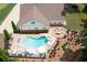 Aerial view of a home's backyard featuring a pool, spa, patio, and outdoor seating surrounded by lush landscaping at 7131 Ridge Rd, Hiram, GA 30141