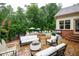Backyard patio with a stone fire pit, white outdoor furniture and the pool can be seen in the background at 7131 Ridge Rd, Hiram, GA 30141