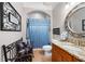 Bathroom featuring a granite countertop vanity, a decorative mirror, a shower with a blue curtain at 7131 Ridge Rd, Hiram, GA 30141