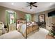 Cozy bedroom with a queen-sized bed, decorative pillows, carpet flooring, and window view at 7131 Ridge Rd, Hiram, GA 30141