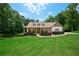Charming home with landscaped front yard and inviting covered front porch at 7131 Ridge Rd, Hiram, GA 30141