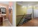 Hallway view with a pedestal sink, wood and tile flooring, a decorative mirror and a wood banister at 7131 Ridge Rd, Hiram, GA 30141