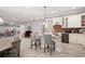 Bright kitchen with a center island, bar seating, and views into an adjacent living space at 7131 Ridge Rd, Hiram, GA 30141