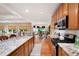 Beautiful kitchen with granite countertops and stainless steel appliances open to the dining and living areas at 7131 Ridge Rd, Hiram, GA 30141