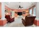 Large seating area in the main bedroom featuring neutral carpet, white columns, and a ceiling fan at 7131 Ridge Rd, Hiram, GA 30141