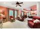 Expansive main bedroom with neutral carpet, a ceiling fan, and comfortable seating with a decorative rug at 7131 Ridge Rd, Hiram, GA 30141