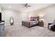 Large main bedroom with a ceiling fan and a king-size bed dressed with pillows and comfortable bedding at 7131 Ridge Rd, Hiram, GA 30141