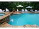 Tranquil backyard retreat with a swimming pool, a spa, and multiple seating areas for relaxation at 7131 Ridge Rd, Hiram, GA 30141