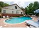 A backyard pool featuring stone coping, a waterfall, and several chairs for lounging by the water at 7131 Ridge Rd, Hiram, GA 30141