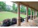 Inviting front porch with stone columns and lush landscaping at 7131 Ridge Rd, Hiram, GA 30141