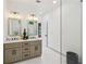 Spacious bathroom features a shower, and dual vanity with decorative lighting at 1129 Victory Sw Dr, Atlanta, GA 30310