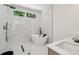 Beautiful bathroom features a soaking tub and marble-style tile in shower at 1129 Victory Sw Dr, Atlanta, GA 30310
