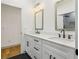 Bathroom showcases a double vanity with marble countertop, modern fixtures, and black-striped floors at 1129 Victory Sw Dr, Atlanta, GA 30310