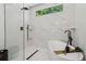 Bathroom featuring a soaking tub, marble-style tile, and black hardware at 1129 Victory Sw Dr, Atlanta, GA 30310