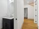 Bathroom with a dark vanity cabinet and light countertops, plus doorway to hall at 1129 Victory Sw Dr, Atlanta, GA 30310