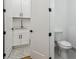 Bathroom featuring white cabinets, a patterned tile floor, toilet, and black hardware at 1129 Victory Sw Dr, Atlanta, GA 30310