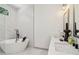 Modern bathroom featuring a soaking tub and marble-style tile in shower at 1129 Victory Sw Dr, Atlanta, GA 30310