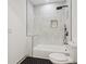 Modern bathroom featuring black shower, white tile, and black-striped floors at 1129 Victory Sw Dr, Atlanta, GA 30310