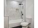 Modern bathroom featuring black shower, white tile, and black-striped floors at 1129 Victory Sw Dr, Atlanta, GA 30310
