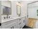 A modern bathroom showcases a double vanity with marble countertop, modern fixtures, and black-striped floors at 1129 Victory Sw Dr, Atlanta, GA 30310