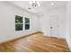 Bright bedroom features hardwood floors, modern lighting, and two large windows with a view at 1129 Victory Sw Dr, Atlanta, GA 30310