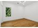 A bright bedroom features hardwood floors, modern lighting, and a large window with a view at 1129 Victory Sw Dr, Atlanta, GA 30310