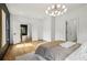 Bright bedroom features an attractive light fixture, hardwood floors, and doorway to hall at 1129 Victory Sw Dr, Atlanta, GA 30310